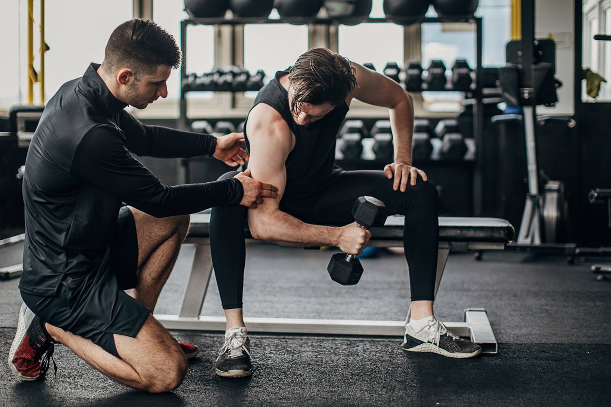 Man having personal training in the gym